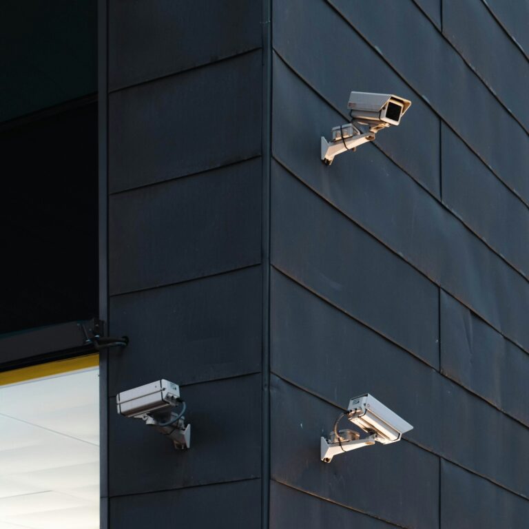 Security cameras mounted on a modern dark building exterior