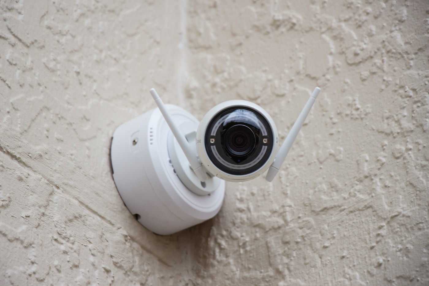 Close-up of a modern home security camera mounted on a wall